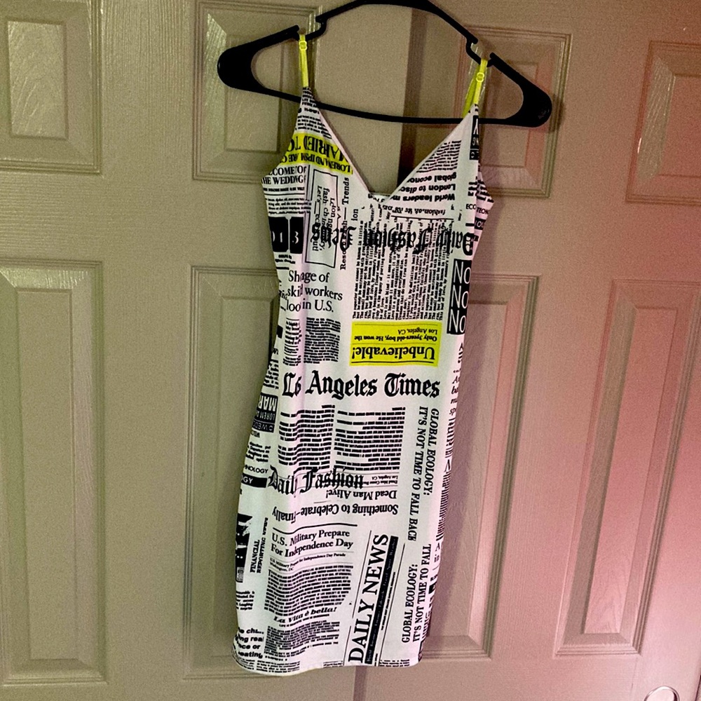 A spaghetti strap news paper mini dress